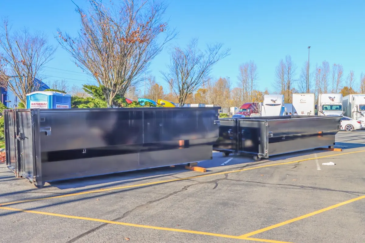 Professional dumpster rental service with roll-off container on residential driveway in Gilbert